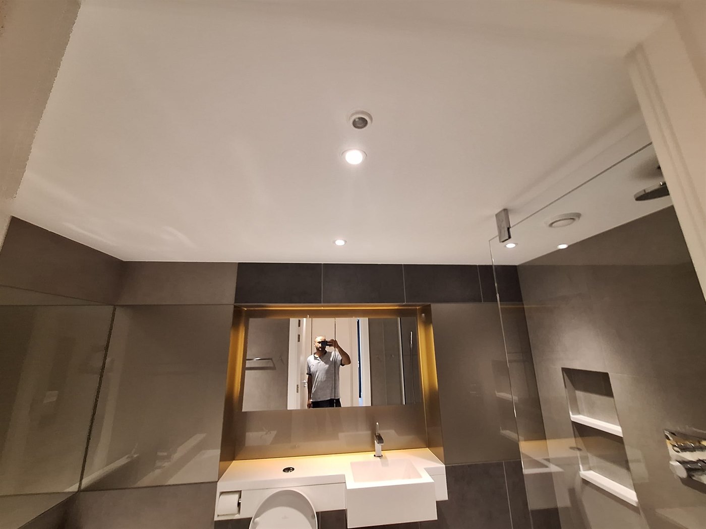 Smooth painted bathroom ceiling in SW11 apartment above a tiled shower room