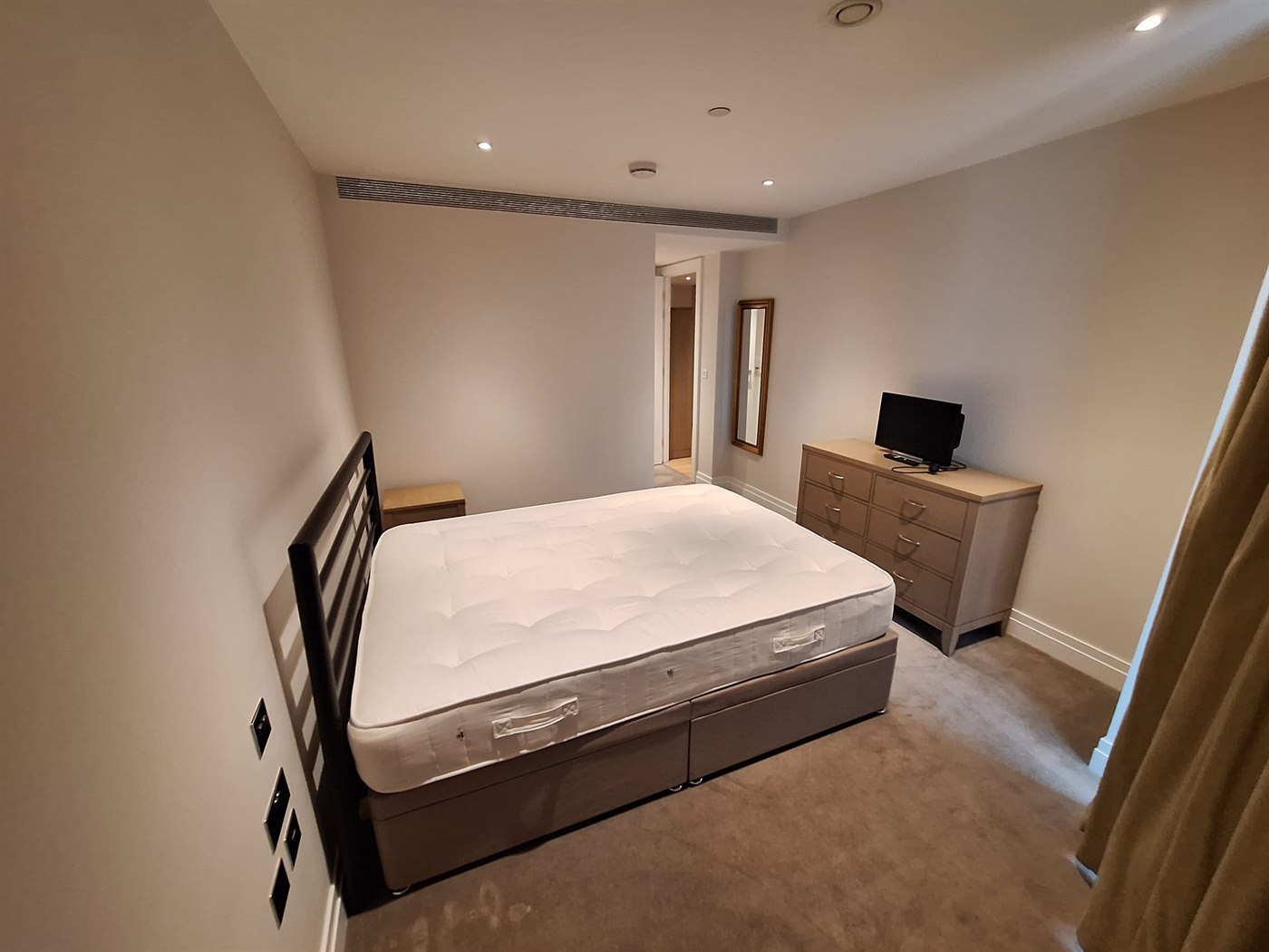 Bedroom repaint in SW11 apartment with soft neutral walls, ceiling, and crisp woodwork