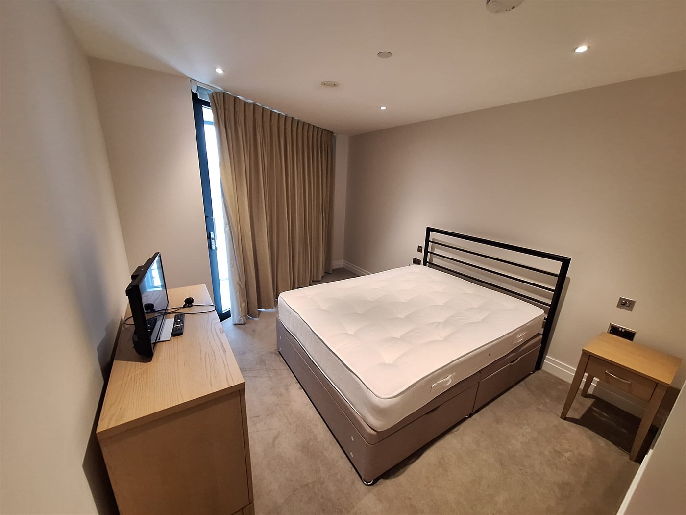 Bedroom interior in SW11 London with neatly painted walls and a calm neutral finish