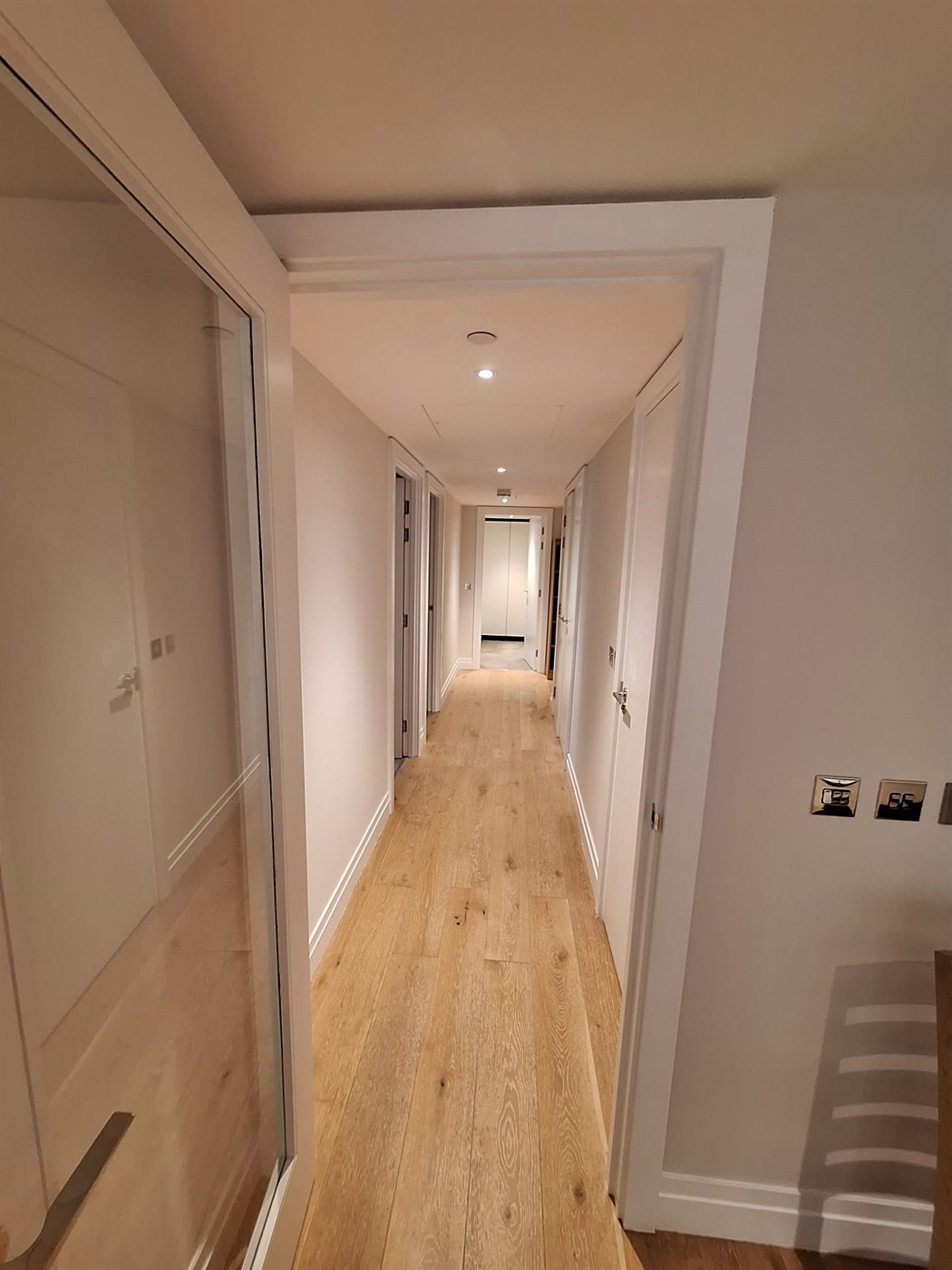 Entrance hallway in SW11 apartment with freshly painted walls, ceiling, and trim