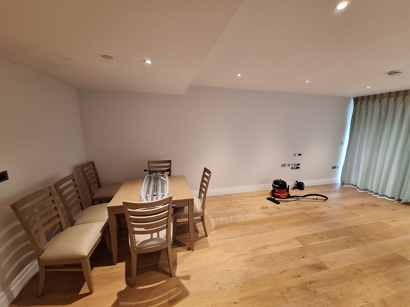 Long corridor repaint in SW11 apartment with consistent neutral walls and crisp woodwork